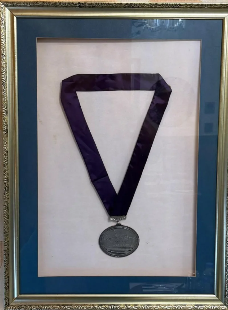 The framed silver medal from the Hong Kong International Culinary Classic, hanging in the restaurant