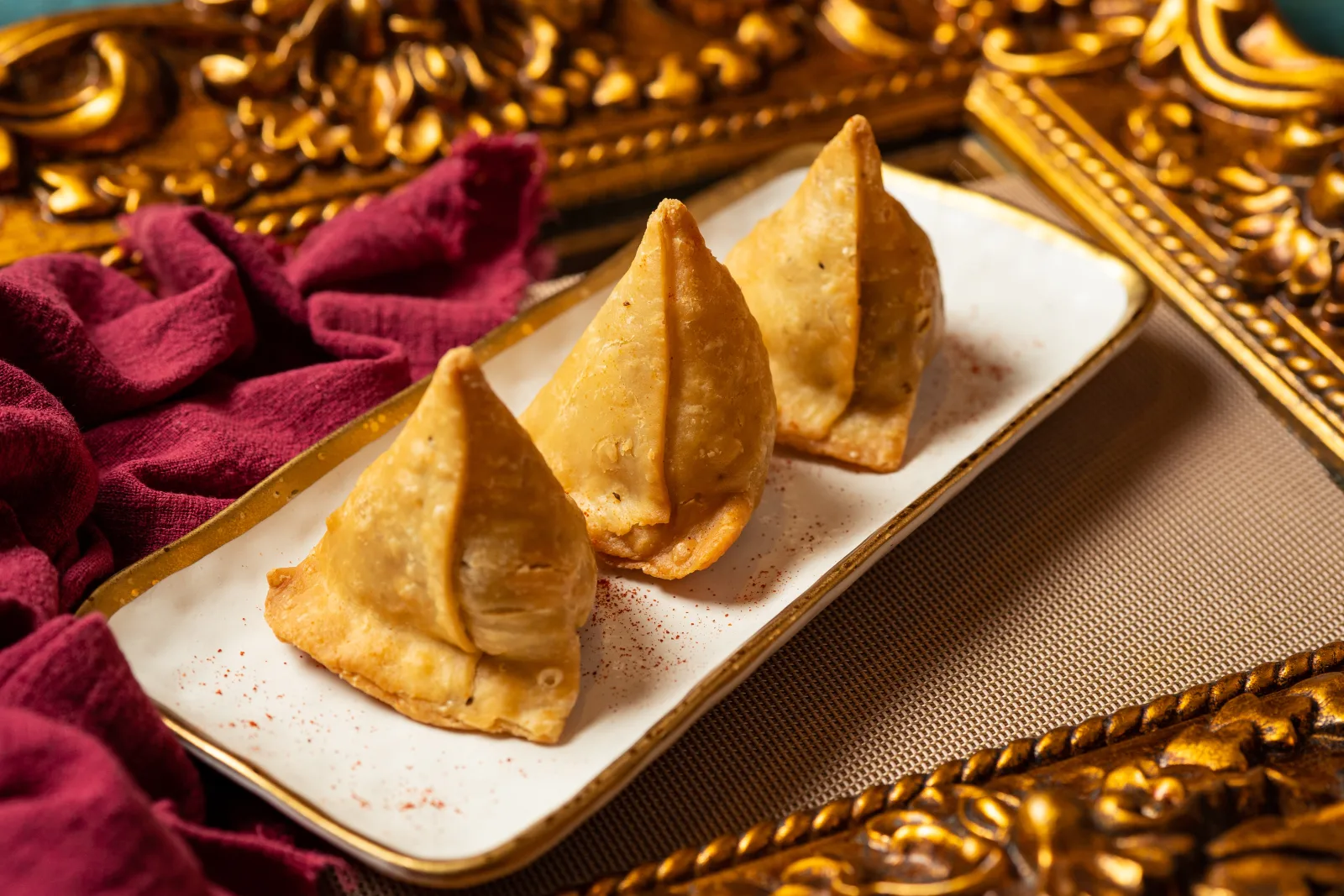 Tulsi samosas against a gilded backdrop