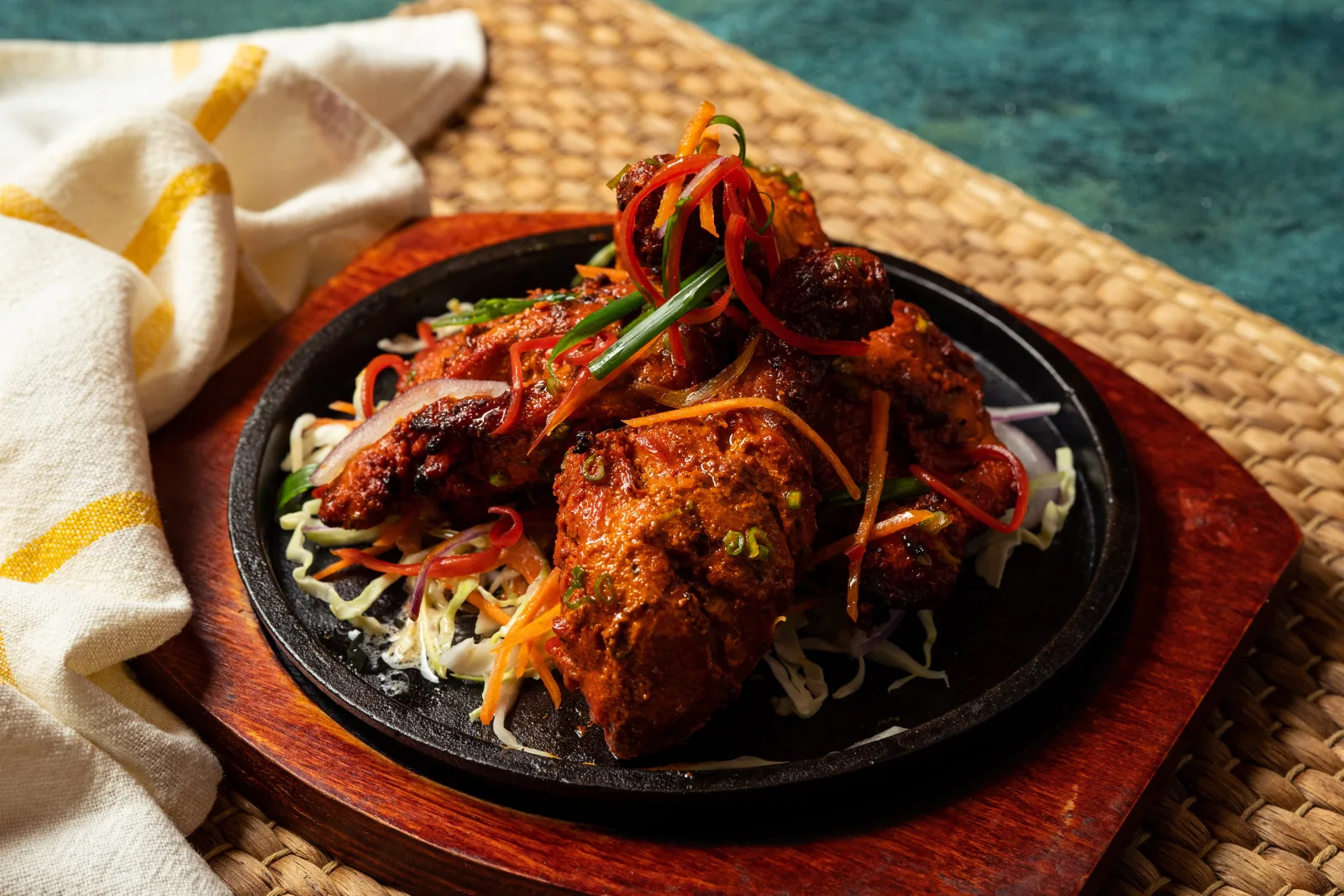 Tandoori chicken on a sizzling platter