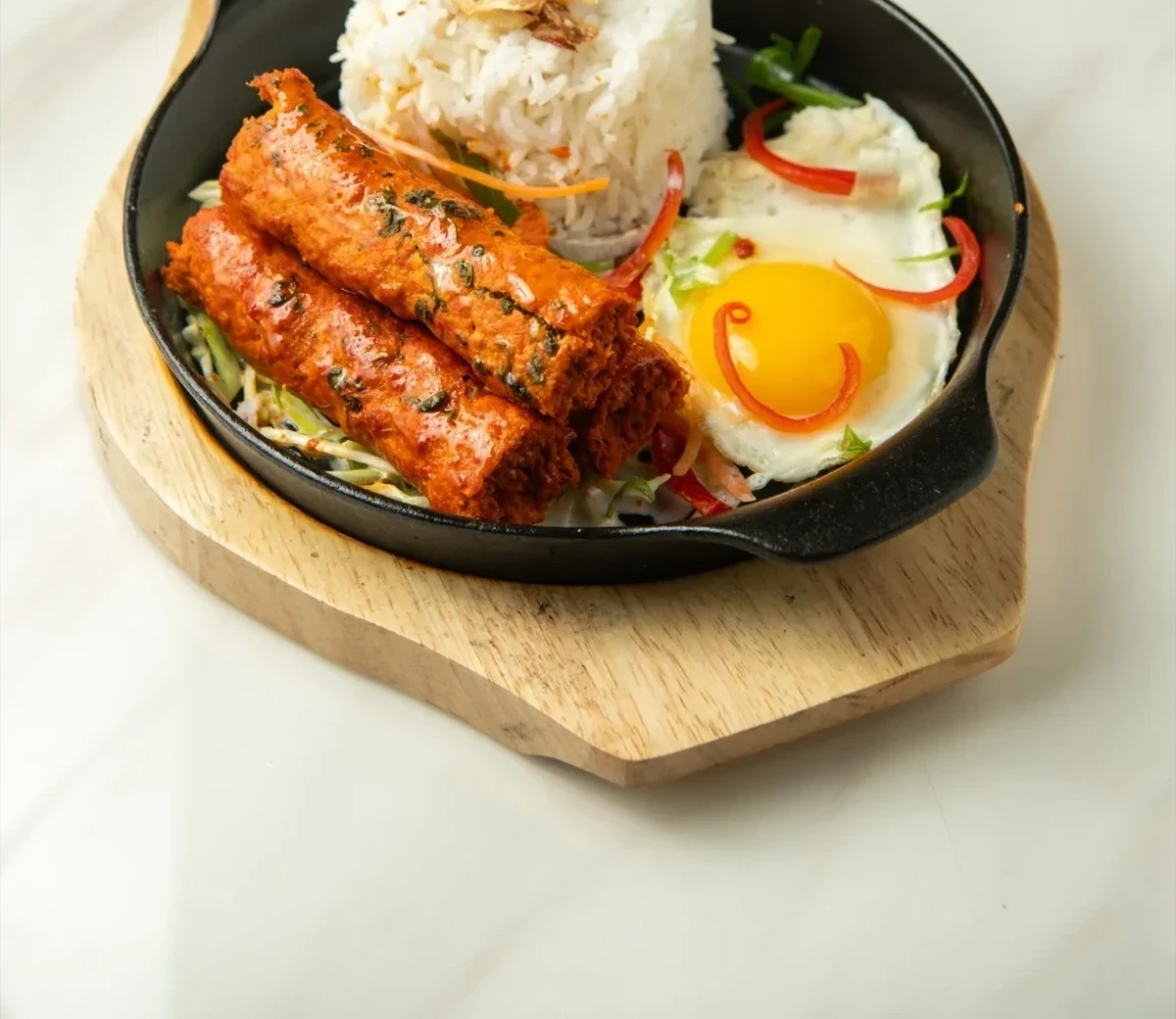 Lamb kebab set lunch - sizzling plate with rice and fried egg